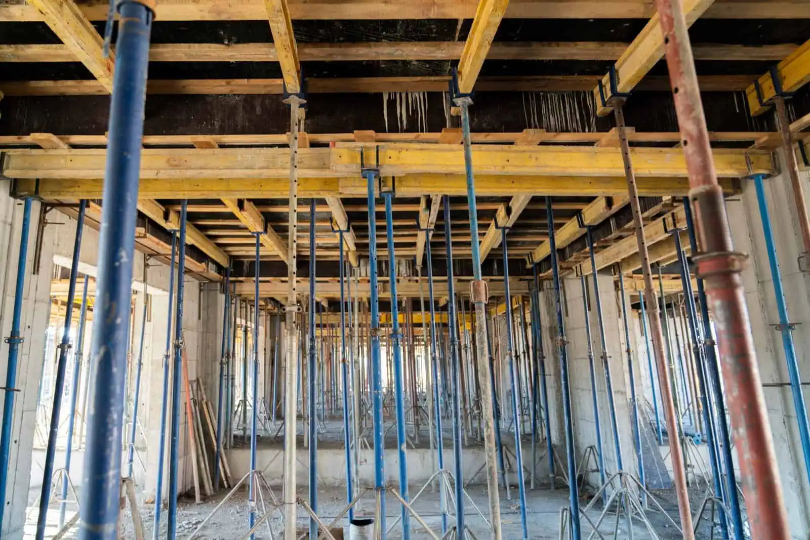 Construction site with scaffolding and support beams for concrete work.